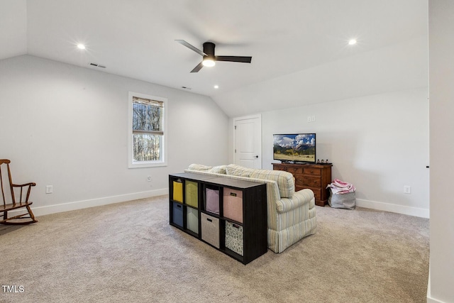 living room featuring lofted ceiling, ceiling fan, and carpet flooring