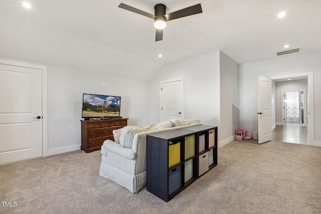 carpeted living room featuring vaulted ceiling and ceiling fan