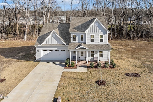 view of front facade with a garage, a front yard, and covered porch