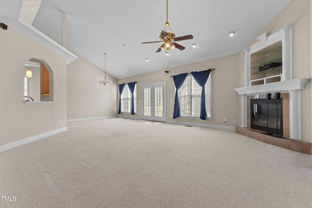 unfurnished living room with ceiling fan, lofted ceiling, and carpet floors