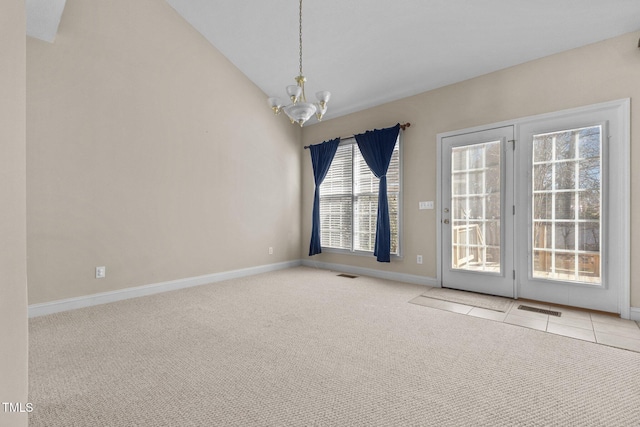 unfurnished room with vaulted ceiling, light carpet, and a chandelier