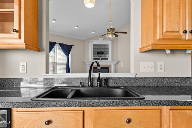 kitchen featuring lofted ceiling, sink, and dishwasher