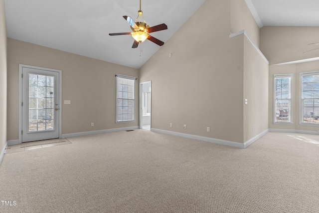 unfurnished living room featuring high vaulted ceiling, light colored carpet, and ceiling fan