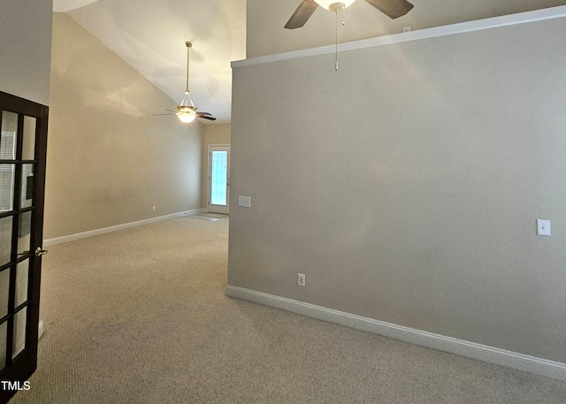 spare room with lofted ceiling, carpet floors, and ceiling fan