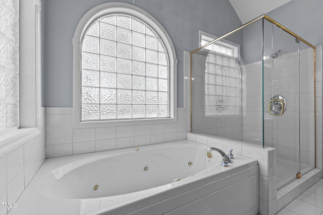 bathroom with lofted ceiling, a wealth of natural light, and independent shower and bath