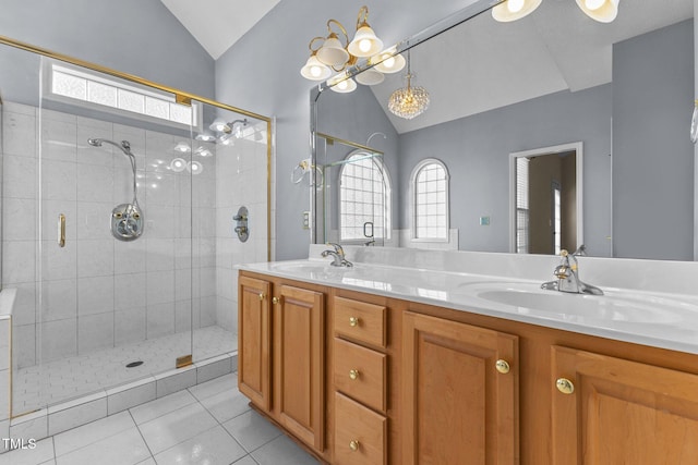 bathroom with vaulted ceiling, walk in shower, tile patterned floors, and vanity