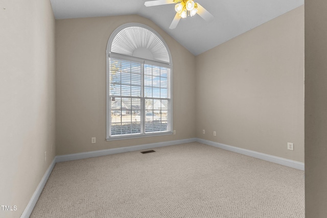 carpeted empty room with lofted ceiling and ceiling fan