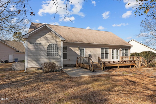 rear view of house featuring a wooden deck, a yard, and a patio