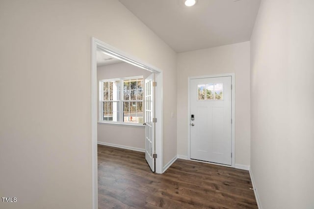 foyer with a healthy amount of sunlight and dark hardwood / wood-style flooring