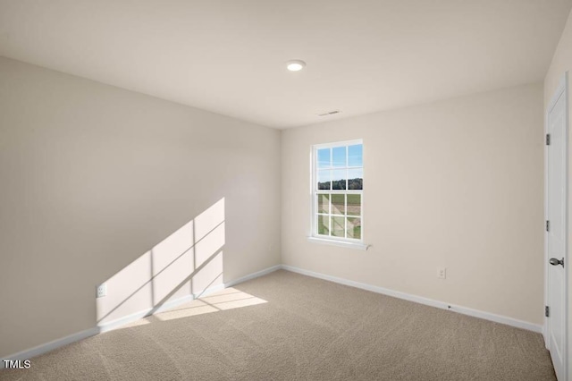 unfurnished room featuring light carpet