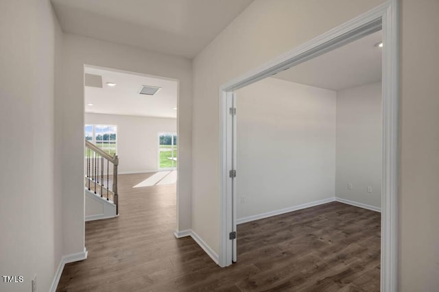 corridor with dark hardwood / wood-style flooring