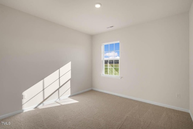 spare room featuring light carpet