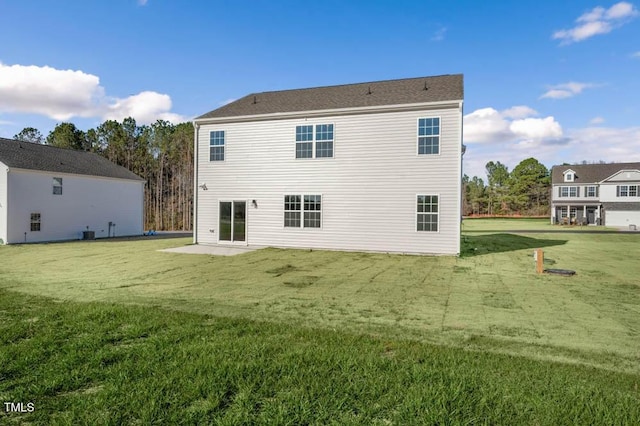 back of property featuring a patio area and a yard