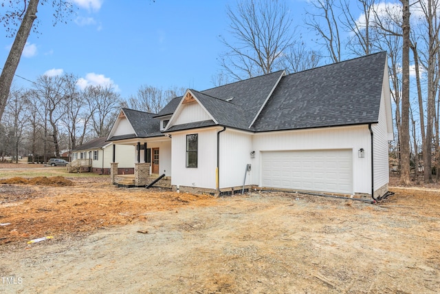 view of front of property featuring a porch and a garage