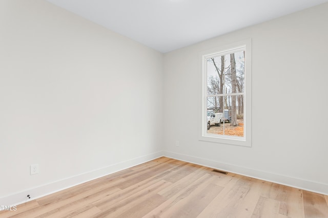 unfurnished room with light wood-type flooring