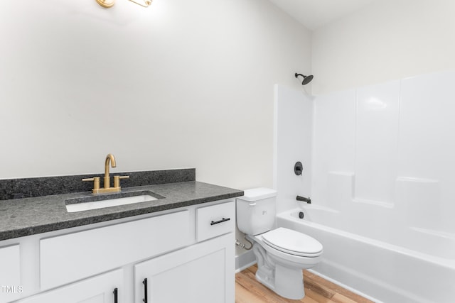 full bathroom featuring tub / shower combination, wood-type flooring, toilet, and vanity