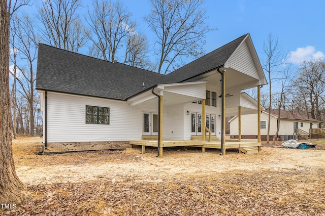 rear view of property with a deck and french doors