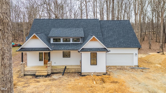 view of front of house with a porch and a garage