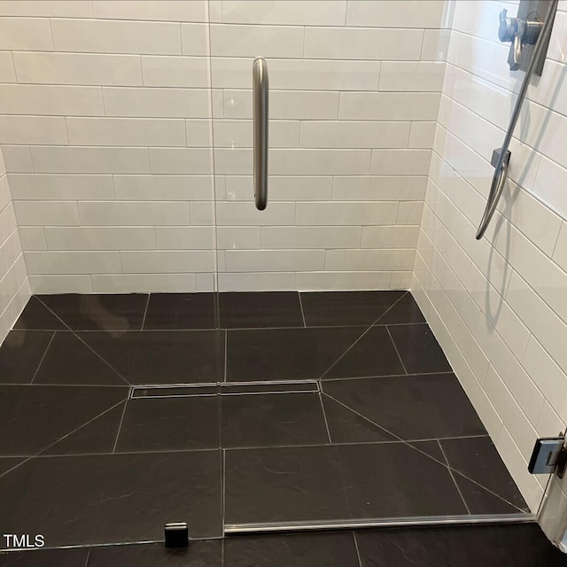 bathroom with tiled shower