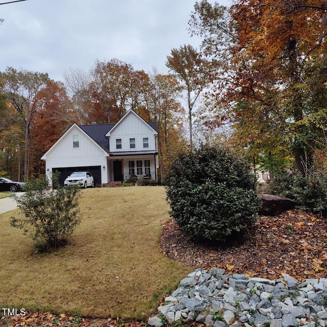 modern inspired farmhouse featuring covered porch, board and batten siding, a front lawn, and a garage
