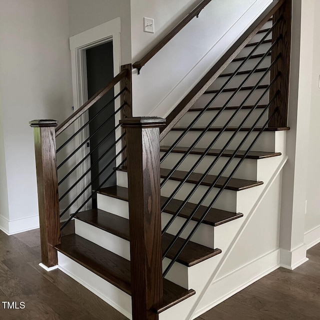 stairs with baseboards and wood finished floors