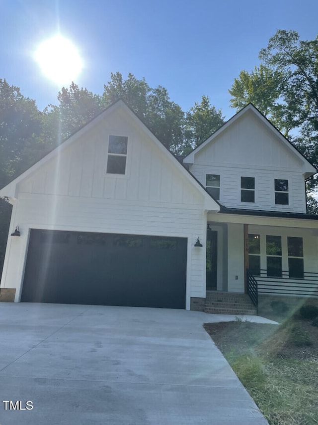 view of front of house featuring board and batten siding and concrete driveway