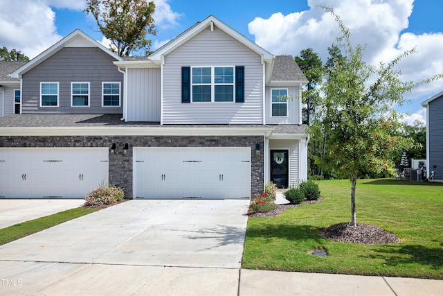 view of front of home featuring a garage, central AC, and a front yard