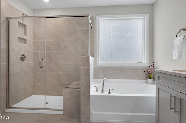 bathroom featuring tile patterned floors, vanity, and plus walk in shower