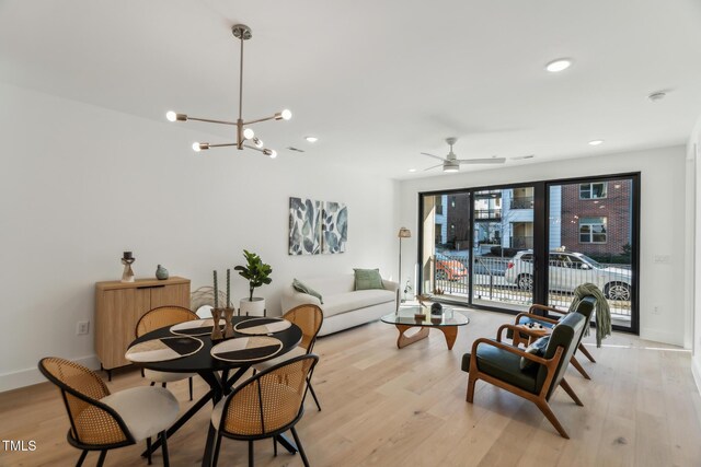 living area featuring recessed lighting, a chandelier, baseboards, and light wood-style flooring