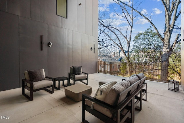 view of patio with an outdoor living space and fence