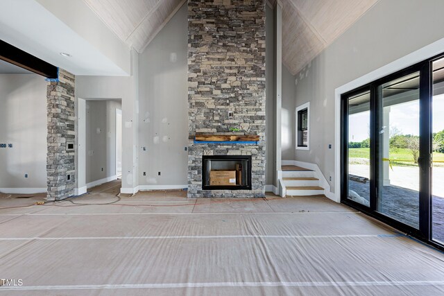 6509 Zebulon Rd, Wake Forest, NC 27587 - unfurnished living room with high vaulted ceiling, a stone fireplace, baseboards, stairway, and wood ceiling