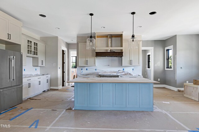 6509 Zebulon Rd, Wake Forest, NC 27587 - kitchen featuring high quality fridge, light countertops, a kitchen island, hanging light fixtures, and baseboards
