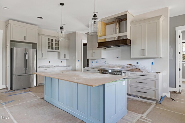 6509 Zebulon Rd, Wake Forest, NC 27587 - kitchen with high end fridge, wall chimney range hood, a center island, decorative light fixtures, and butcher block counters