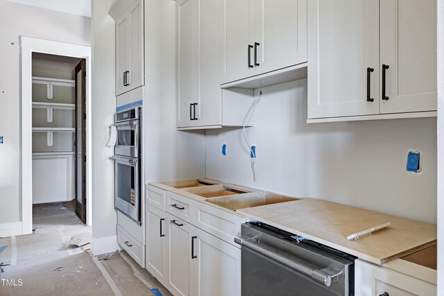 6509 Zebulon Rd, Wake Forest, NC 27587 - kitchen featuring appliances with stainless steel finishes, white cabinets, light countertops, and baseboards