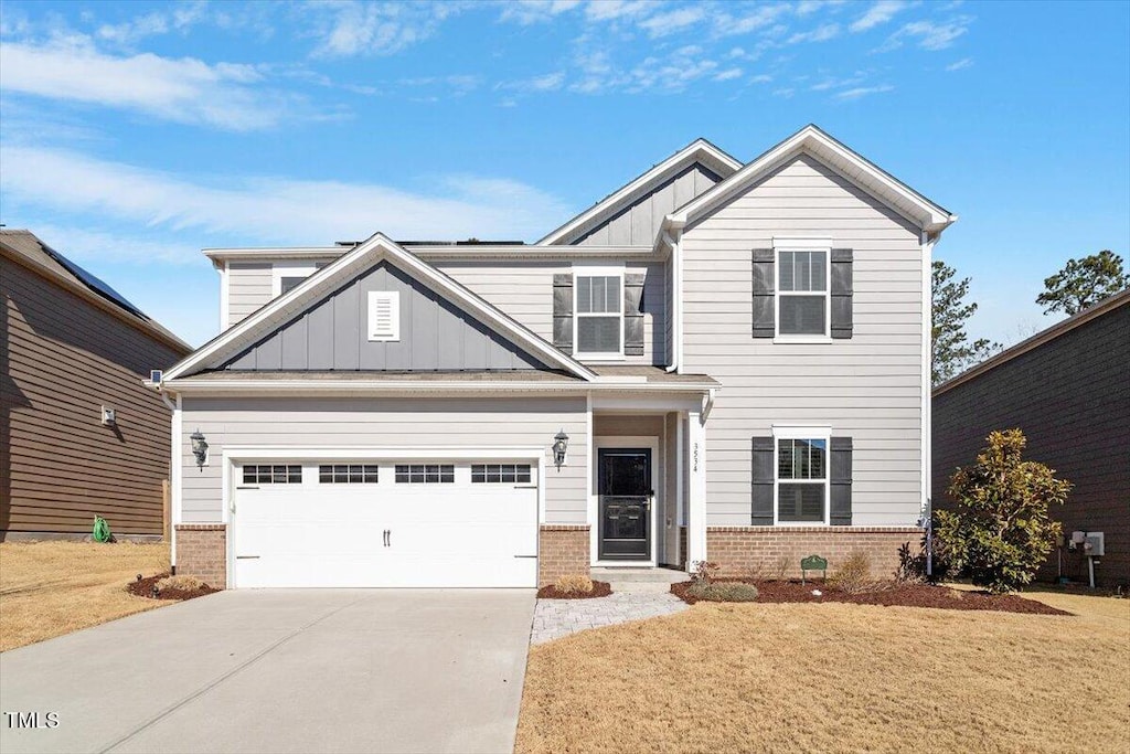 craftsman-style home with a garage and a front yard