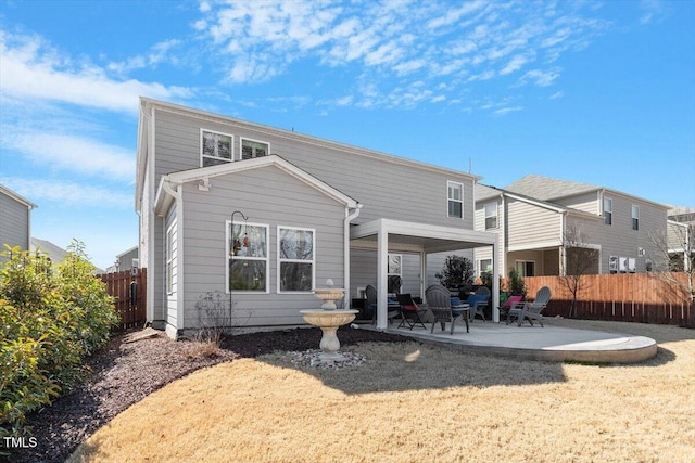 rear view of property featuring a patio area and a lawn