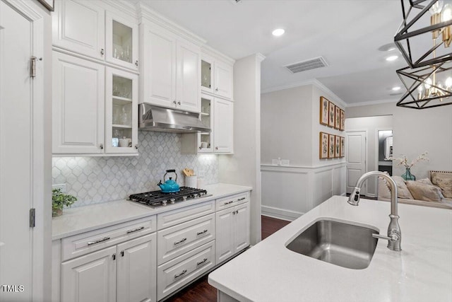 kitchen with sink, white cabinetry, ornamental molding, pendant lighting, and stainless steel gas stovetop