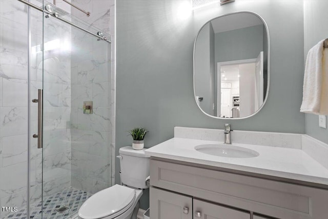 bathroom with vanity, an enclosed shower, and toilet