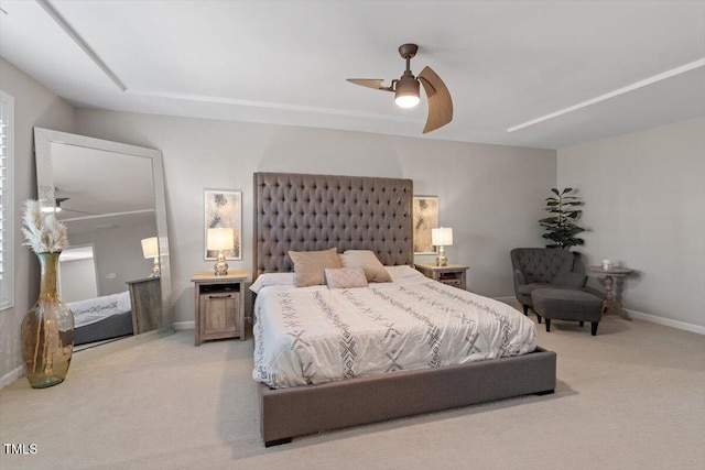 bedroom featuring ceiling fan and light carpet