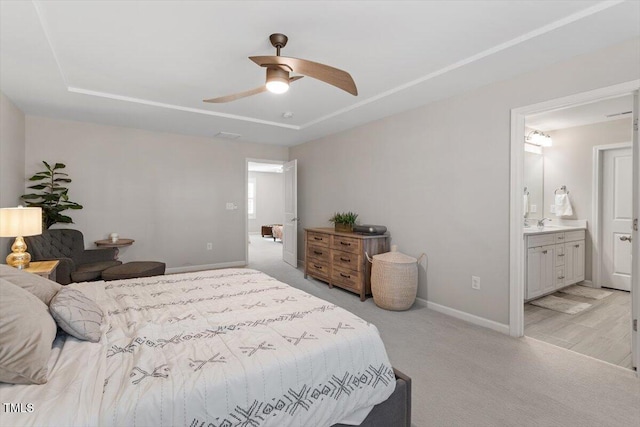 carpeted bedroom with sink, connected bathroom, and ceiling fan