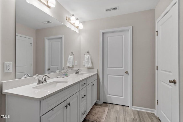 bathroom featuring vanity and wood-type flooring