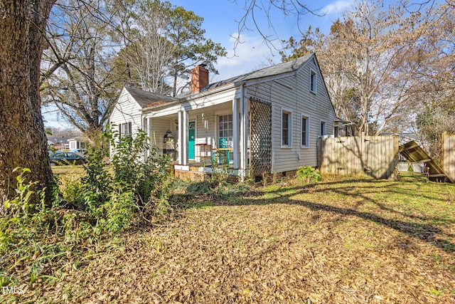 exterior space with covered porch and a yard