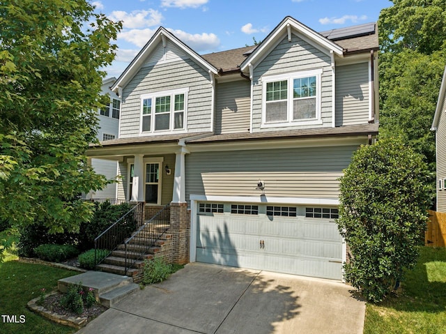 craftsman-style house with a porch, a garage, and solar panels