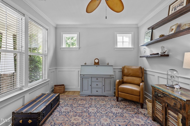 living area with ornamental molding, light wood-type flooring, and plenty of natural light