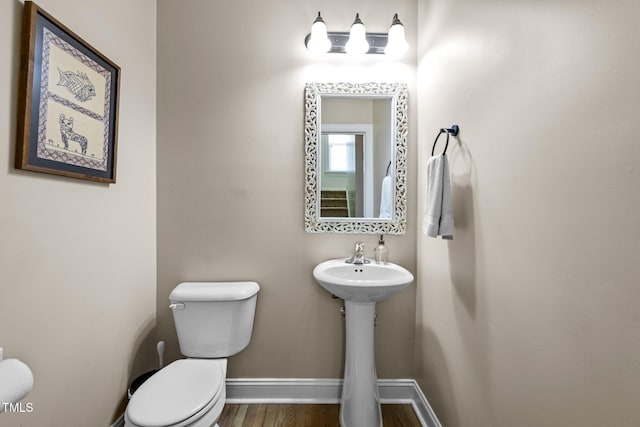 bathroom with toilet and hardwood / wood-style floors