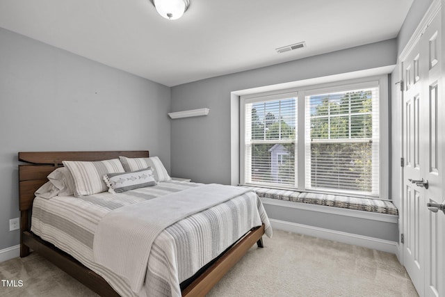 bedroom featuring light colored carpet