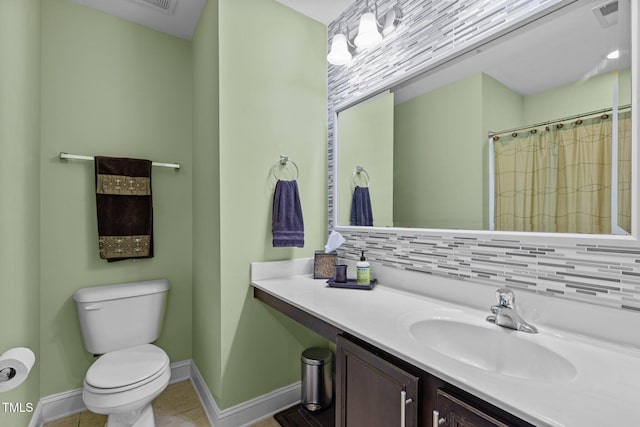 bathroom featuring tasteful backsplash, tile patterned flooring, vanity, walk in shower, and toilet