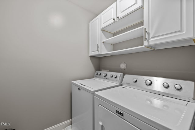 laundry room with cabinets and separate washer and dryer