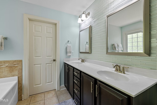 bathroom featuring a tub to relax in, vanity, and tile patterned flooring