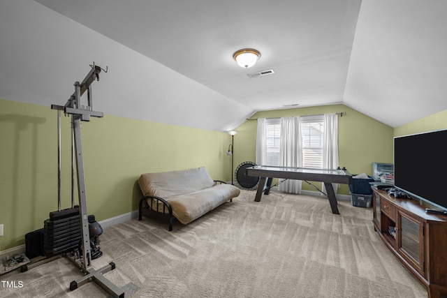 home office with vaulted ceiling and light carpet